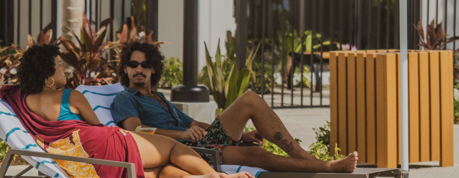 a man and women sitting by a pool