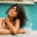 a woman sitting by a pool