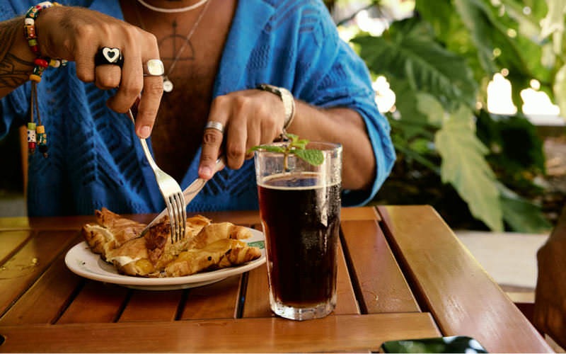 man eating at an outdoor table