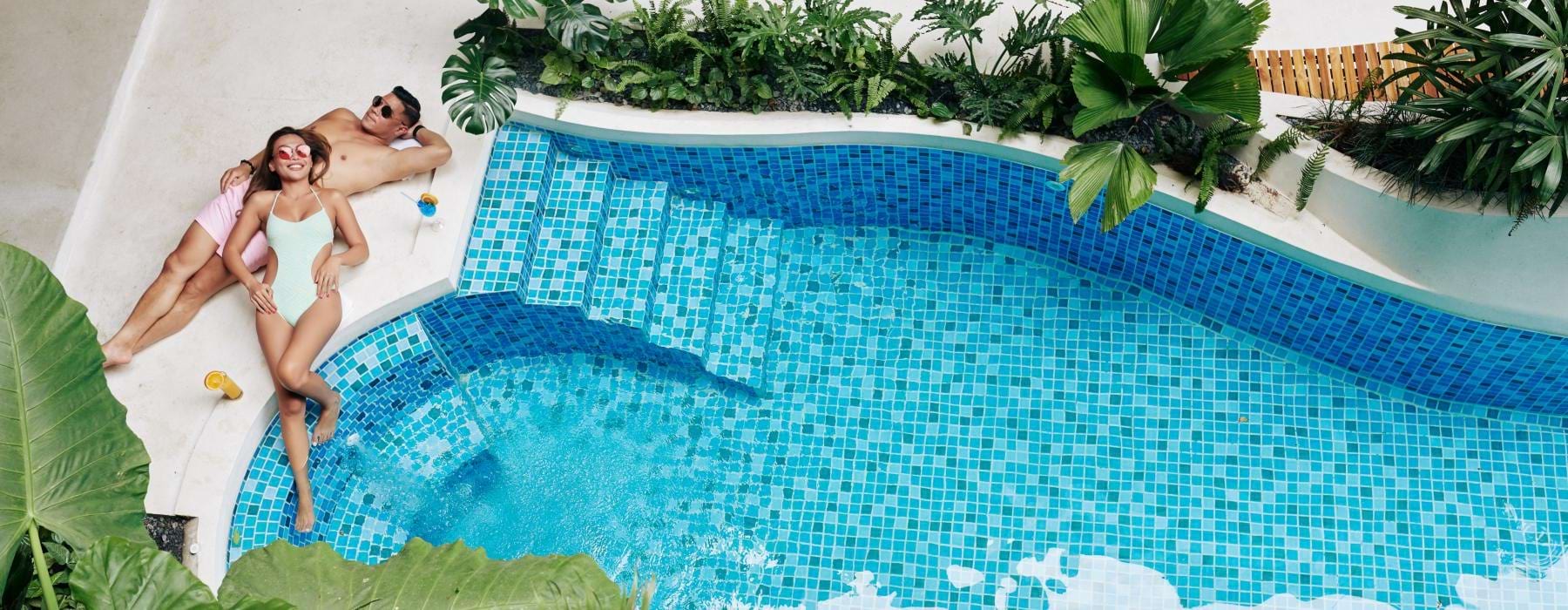 a person in a garment standing on a pool